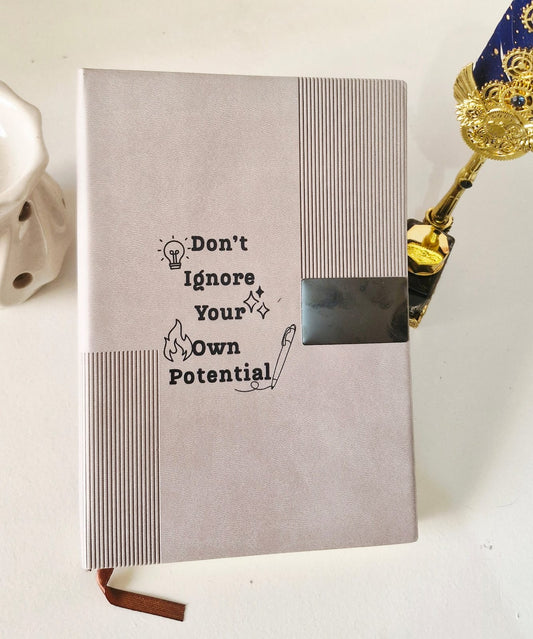 Minimal desk setup featuring an undated ivory page diary with soft leather-finish cover