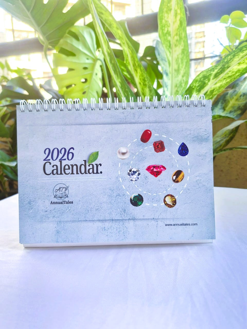 2026 Navratna desk calendar cover featuring gemstones and zodiac-inspired graphics.
