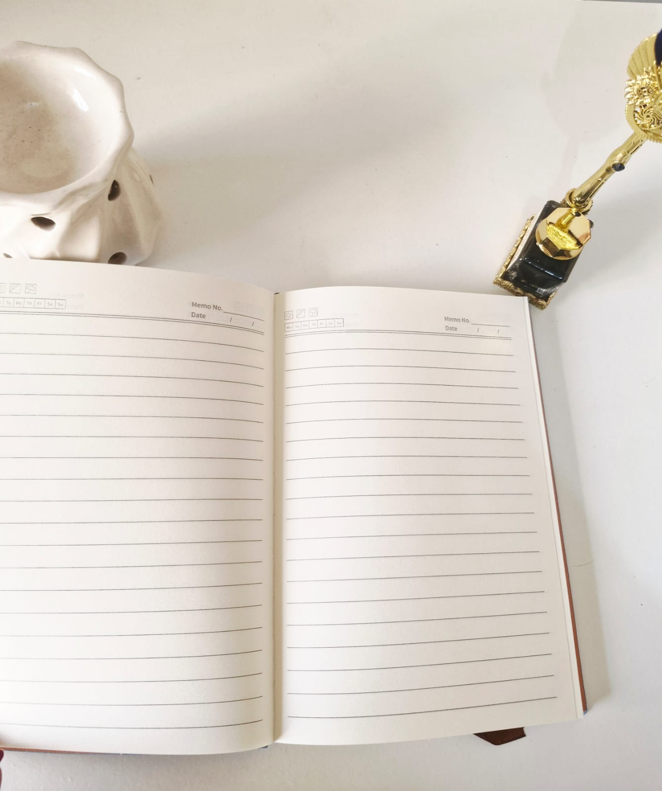 Open undated diary showing clean lined ivory pages designed for everyday writing and journaling