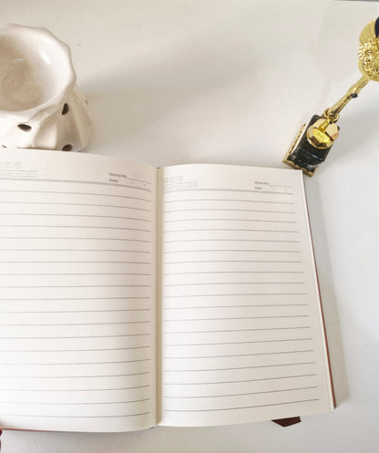 Open undated diary showing clean lined ivory pages designed for everyday writing and journaling