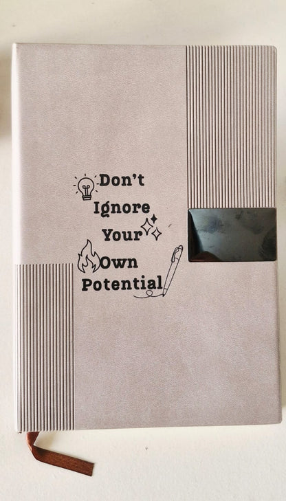 Undated ivory page diary with soft leather-finish cover in beige, featuring the quote “Don’t Ignore Your Own Potential”